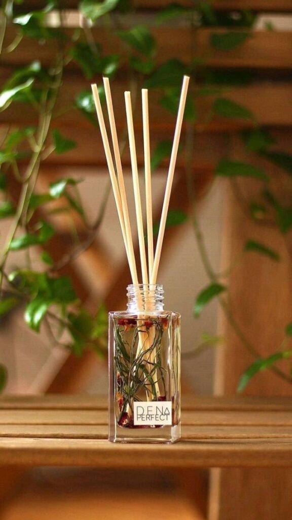 49+ Christmas Bedroom Decor Ideas That Make Your Room Feel Like a Winter Fairytale 16 Pinecone Scented Reed Diffuser Beside the Bed